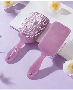 Detailed view of two purple square air cushion hair brushes with floral totem prints