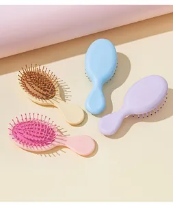 Detailed view of four colorful mini air cushion hairbrushes for portable hair care
