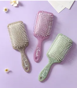 Detail view of square cushion hairbrushes with floral patterns and soft massage bristles