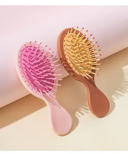 Macro detail view of pink and brown mini air cushion hairbrushes for gentle hair detangling
