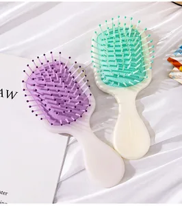Pearlescent mini air cushion hairbrushes in pastel purple and off-white colors