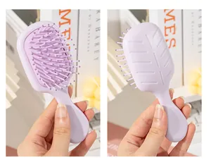 Detailed view showing both sides of a lavender mini portable airbag massage hairbrush