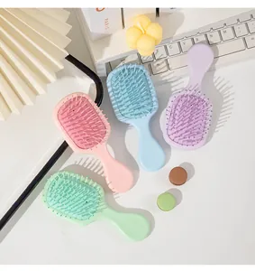 Detailed top view of four pastel mini portable air cushion massage hairbrushes