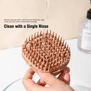 Silicone scalp massage shampoo brush being rinsed under running water