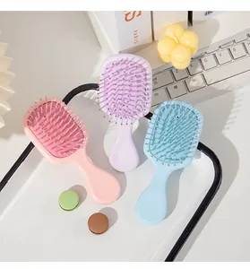 Set of three mini pastel cushion hairbrushes in pink, purple, and light blue colors