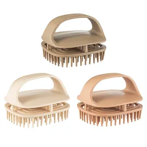 Three Japanese silicone scalp massager shampoo brushes in earth tones on plain background