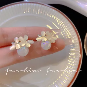 Close-up of elegant 925 silver needle flower stud earrings with iridescent pearls