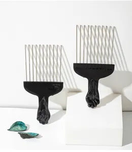 Detailed view of professional metal pin Afro combs with black fist handles
