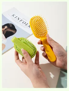 Close-up of portable cactus-shaped folding hairbrushes in yellow and green colors