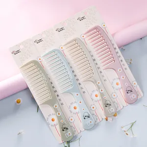 Pastel daisy print hair combs set of 4 with packaging on pink background