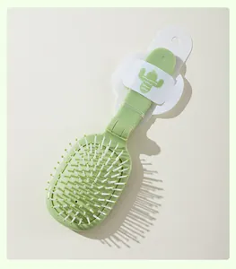 Detail of green cactus folding air cushion hairbrush with portable design for travel