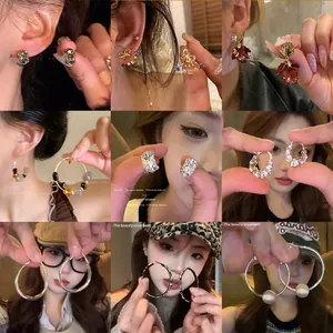 Collection of trendy ins-style earrings including hoops, pearls, and rhinestone studs.