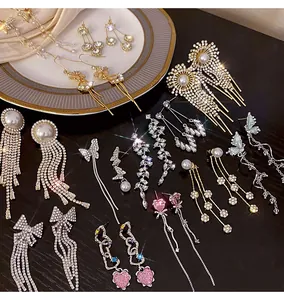 Detailed view of elegant long tassel earrings with sparkling rhinestones and pearls