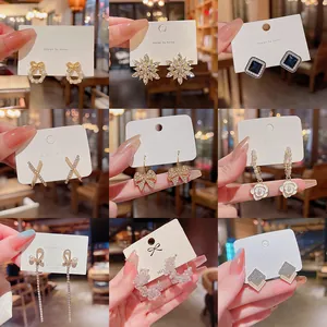 Collection of 9 elegant S925 silver needle earrings featuring crystal bows and flowers