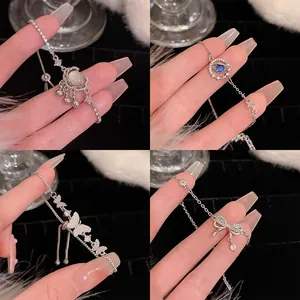 Detailed view of silver cubic zirconia bracelets featuring moon, butterfly, and bow charms