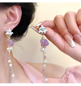 Detail view of S925 silver needle flower earrings with purple and pearl tassels.