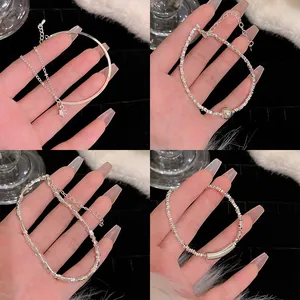 Detailed showcase of four minimalist silver-colored adjustable bracelets with elegant charms