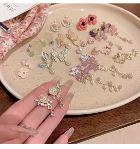 Detailed view of various elegant S925 silver flower and butterfly earrings with pearls