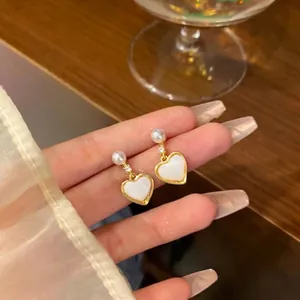 Elegant 925 silver needle pearl heart drop earrings with a sweet and chic gold finish.