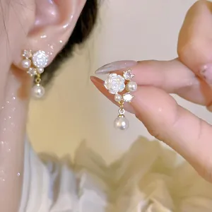 Elegant floral stud earrings featuring white rose, pearl drop, and zircon accents
