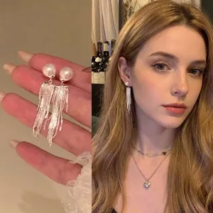 Exquisite pearl tassel drop earrings featuring silver chain fringe shown on a model