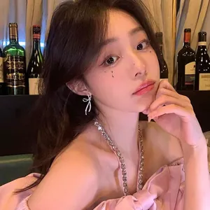 Elegant Korean style sparkling zircon bow earrings shown on a model in a warm setting