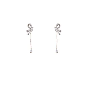 Elegant silver-toned bow knot drop earrings featuring shimmering cubic zircon stones
