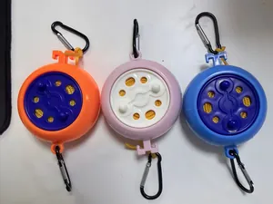 Detailed view of three colorful portable retractable clotheslines with carabiners.