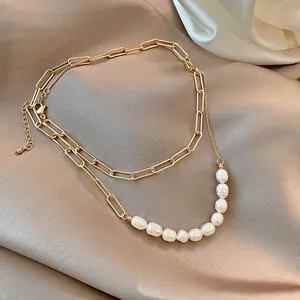Elegant gold-tone layered necklace featuring vintage paperclip links and baroque pearls