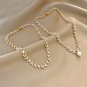 Vintage gold chain necklace with inlaid pearls and rhinestones on satin.