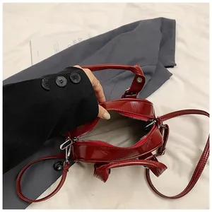 Detail view of a vintage red glossy leather handbag showing the interior capacity.