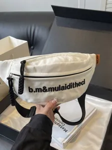 Trendy white canvas fanny pack with black embroidery and adjustable strap