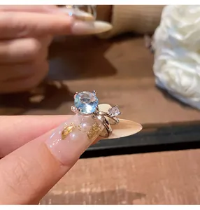 Detailed close-up view of a silver-toned ear cuff featuring a sparkling light blue zircon stone