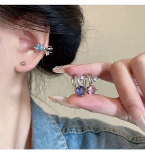 Detailed close-up showing colorful zircon ear cuffs with a sparkling finish and fit.