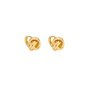 Elegant golden metal knot huggie hoop earrings featuring a sophisticated twisted design