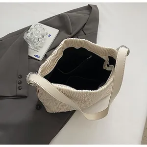 Detailed view of cream pleated tote bag interior showing large storage space and lining