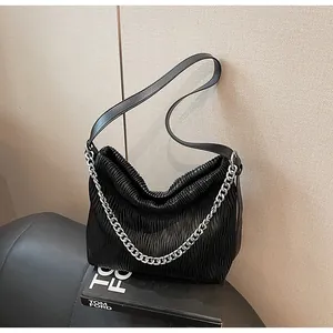 Detailed view of the black pleated leather hobo bag with a silver metal chain