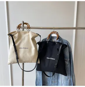 Large canvas tote bags with stylish bamboo handles available in black and cream