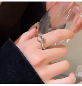 Detailed view of a sparkling silver snake open ring with intricate stone settings