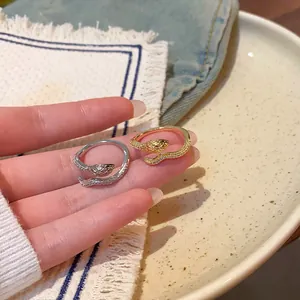 Elegant gold and silver snake shaped open rings with sparkling cubic zirconia accents.