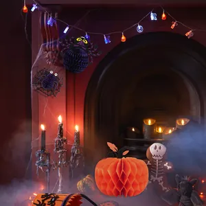 Close-up detail of 3D honeycomb paper pumpkin and spider Halloween party decorations