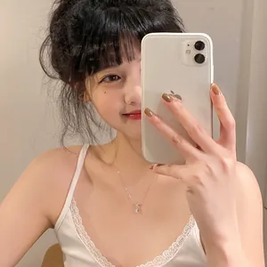 Close-up of the elegant mermaid tear drop necklace displayed on a model in a mirror