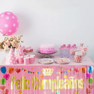 Pink birthday party table skirt fringe banner with golden Feliz Cumpleaños lettering