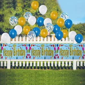 Blue Happy Birthday fringe banner with assorted balloons displayed on a white fence