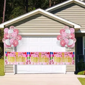 Outdoor pink Happy Birthday tinsel curtain banner with decorative balloon arches for parties