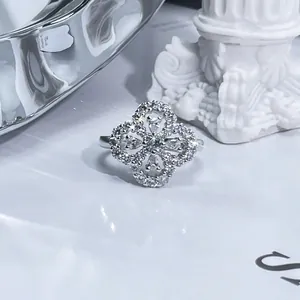 Close-up of sparkling four-leaf clover open ring paved with cubic zirconia stones