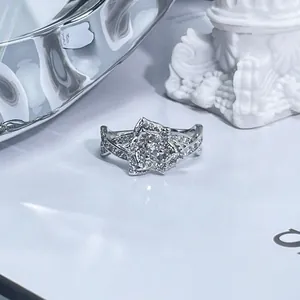 Close-up macro view of sparkling floral pavé ring with intricate silver band detailing