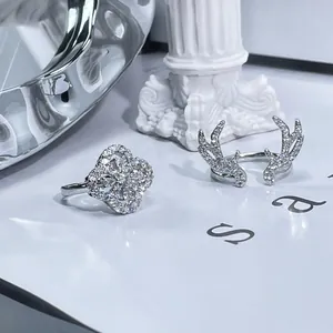 Detailed view of luxury silver antler and four-leaf clover pavé rhinestone rings