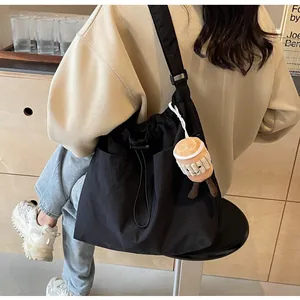 Large black nylon tote bag for women in a casual lifestyle commuter setting