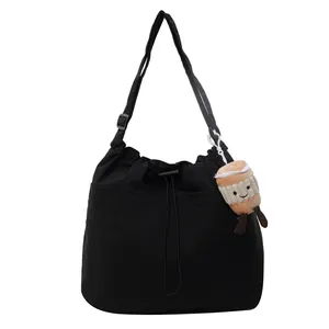 Large capacity black nylon tote bag with drawstring closure and cute plush charm